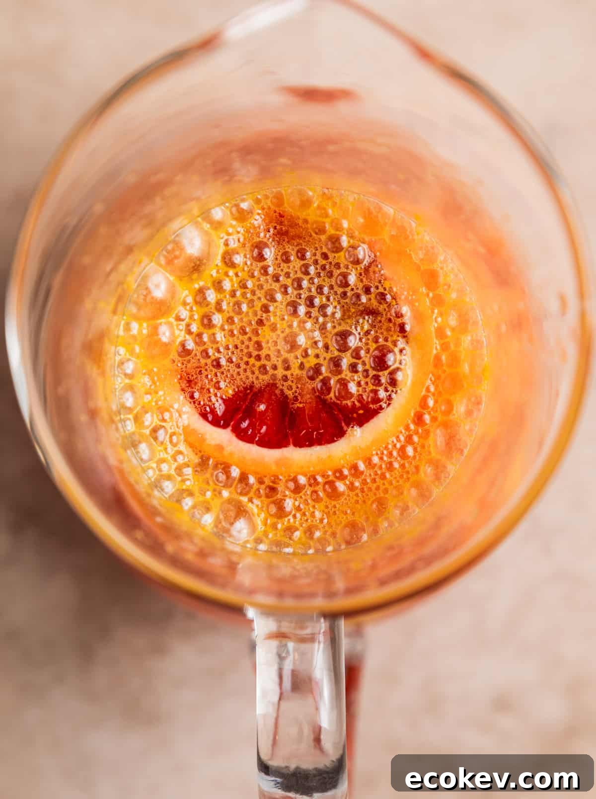 Pitcher with blood orange sangria, champagne just added.