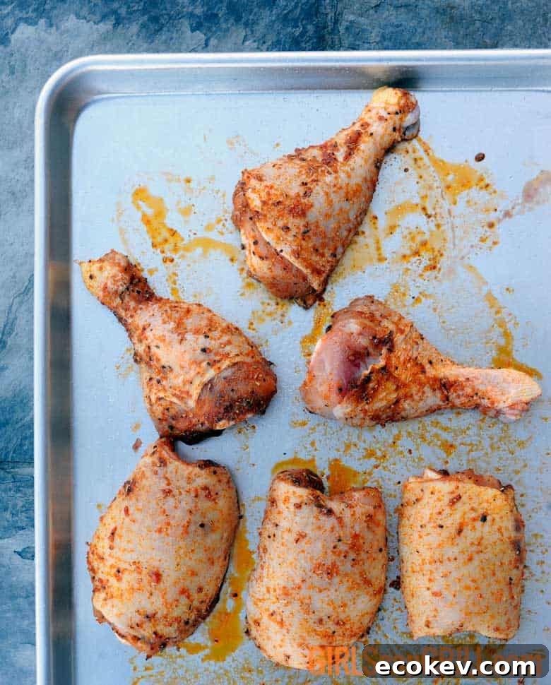 seasoned chicken thighs and legs on pan
