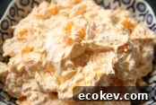 A serving bowl of orange tapioca jello salad.
