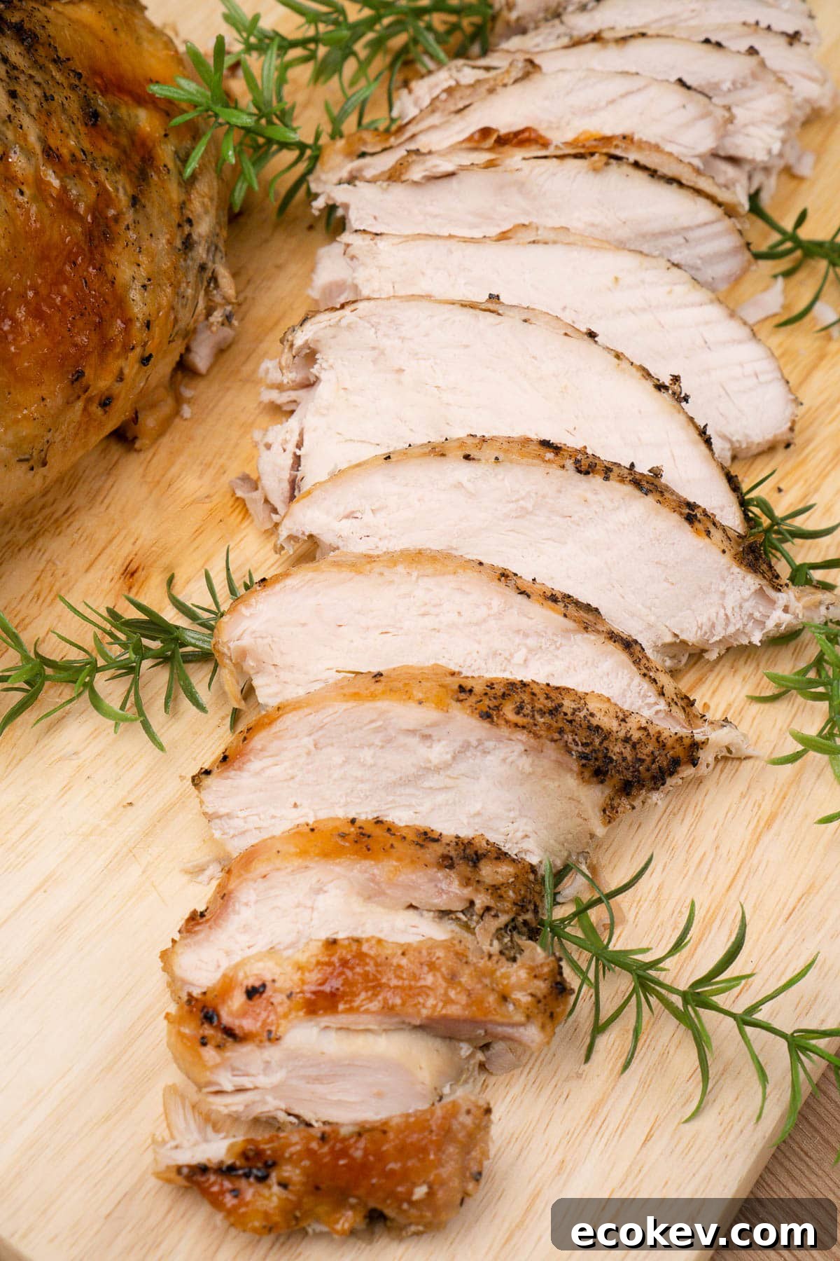 Slow cooker turkey crown breast slices on a wooden copping board