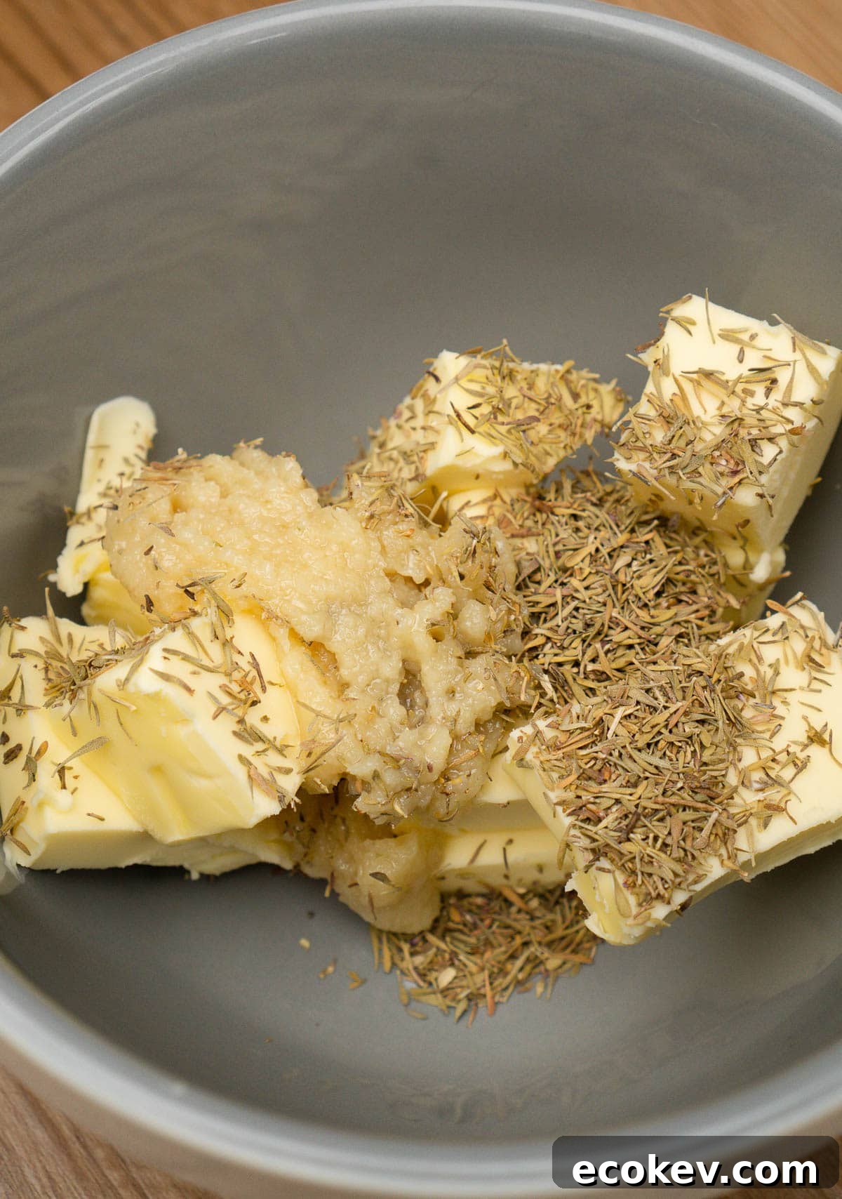 Butter, garlic and dried thyme in a grey bowl