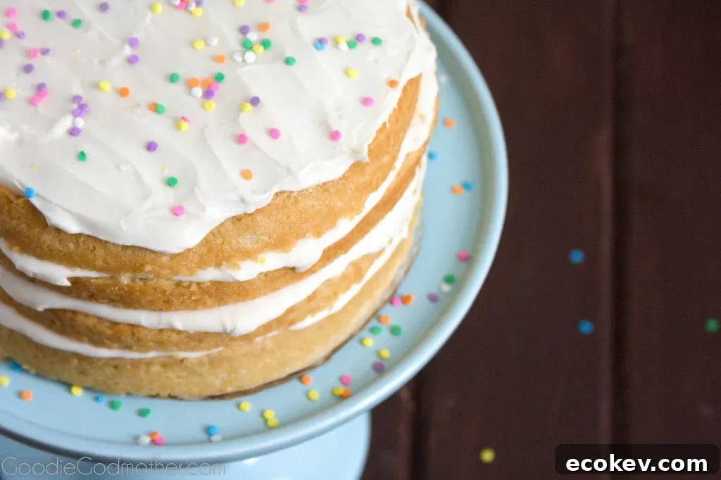 Layers of lemon and cream cheese frosting make this VEGAN lemon cream cake a hit with everyone! Visit GoodieGodmother.com for the recipe