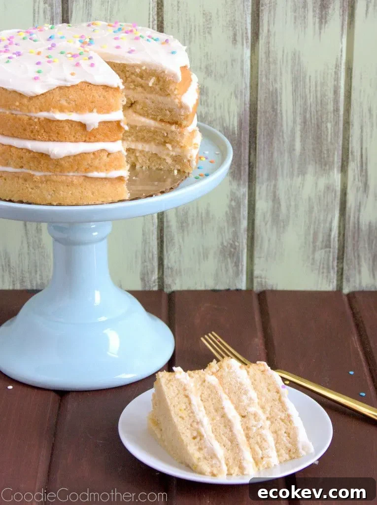 Layers of lemon and cream cheese frosting make this VEGAN lemon cream cake a hit with everyone! Visit GoodieGodmother.com for the recipe