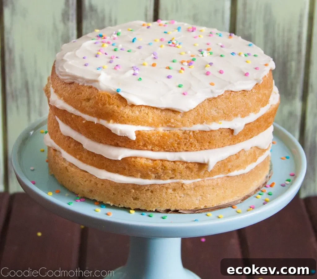 Layers of lemon and cream cheese frosting make this VEGAN lemon cream cake a hit with everyone! Visit GoodieGodmother.com for the recipe