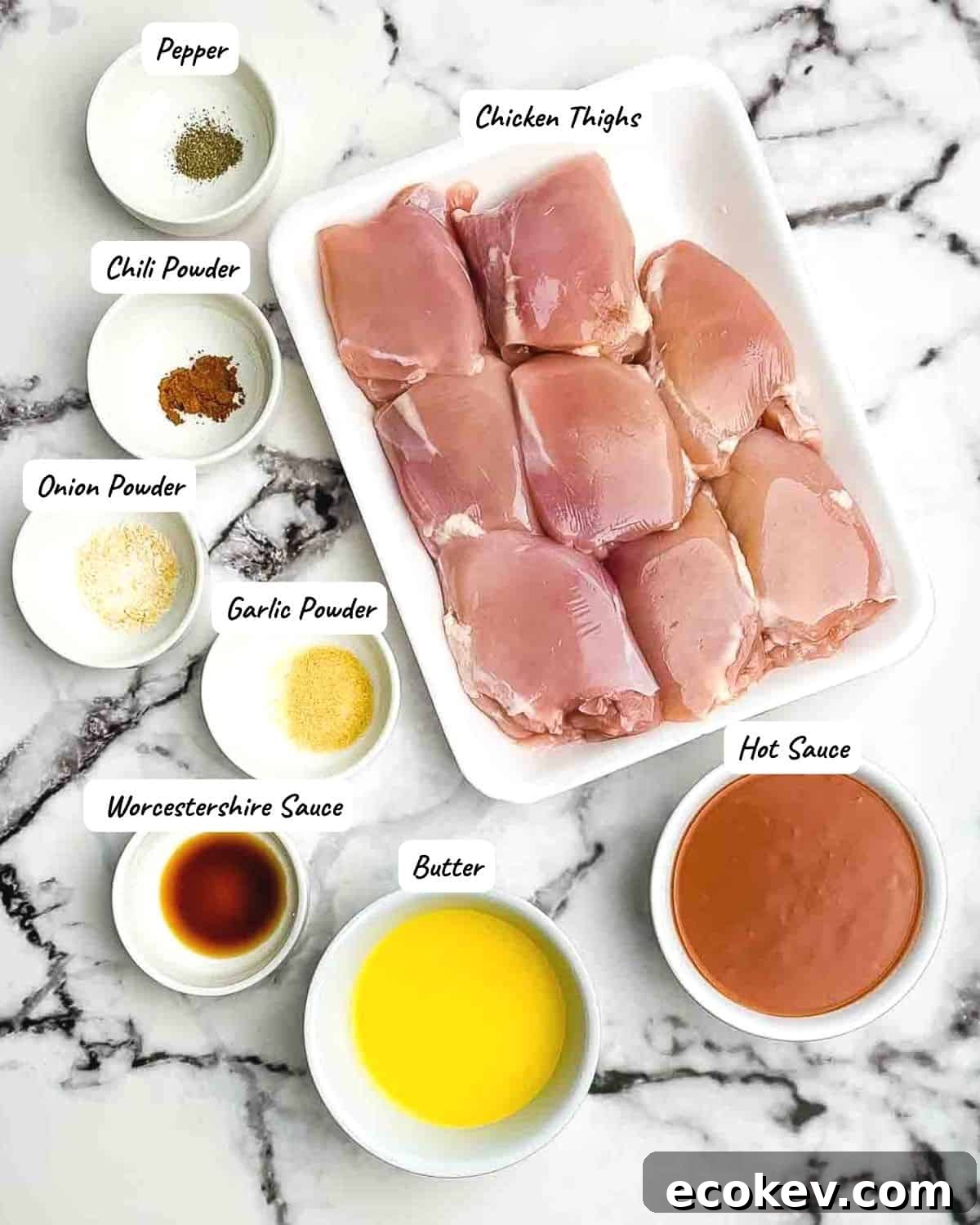 Ingredients for buffalo chicken thighs measured out and placed on a white countertop.