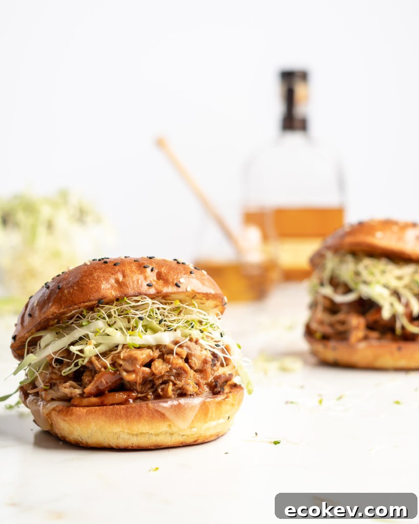 chicken is added to the slow cooker with honey bourbon bbq sauce, to make sweet, smoky, tender bbq chicken sandwiches