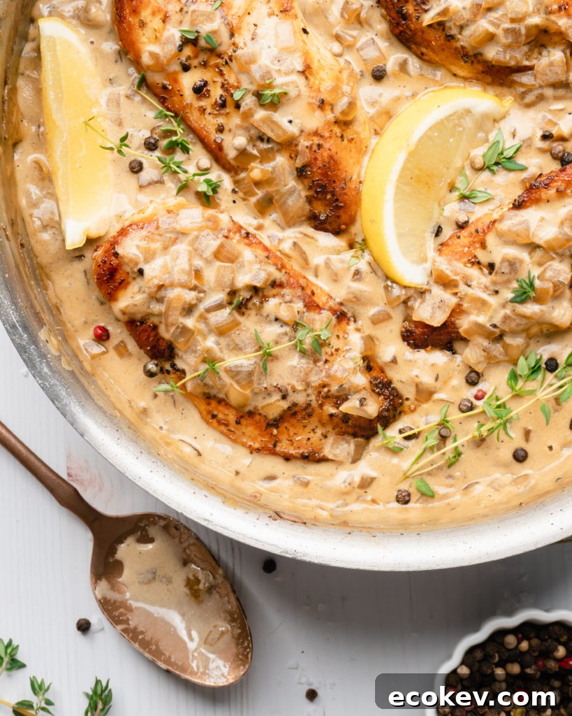 Chicken in pan, topped with white wine cream sauce
