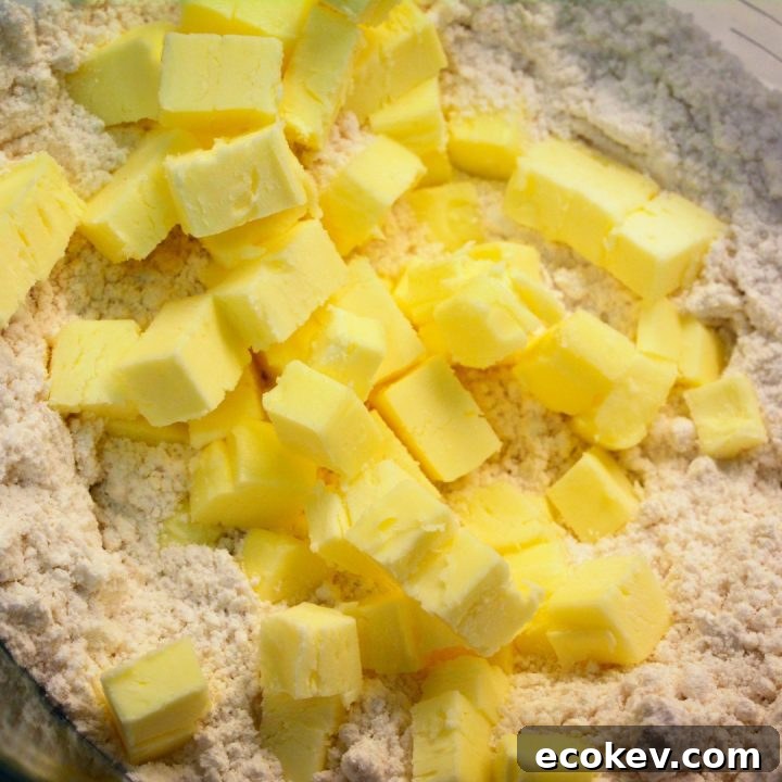 Dump the biscuit mix in a large mixing bowl and then add the cold butter, diced into small pieces or cubes. You can also grate the butter.