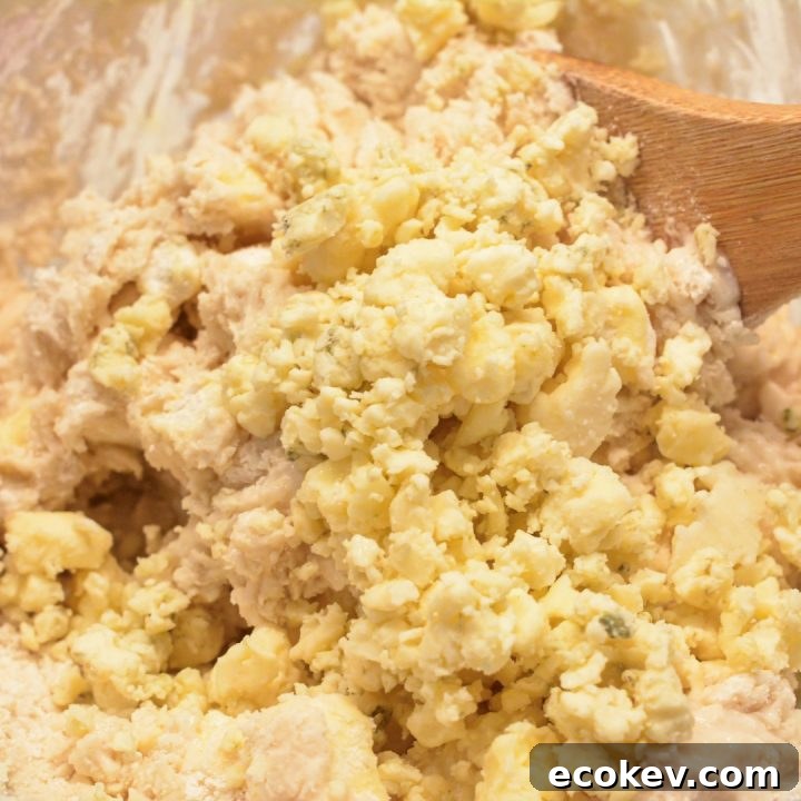 Cut the butter chunks into the bisquick. Then add the blue cheese and buttermilk. Stir to just combine. The dough will be sticky but not runny.