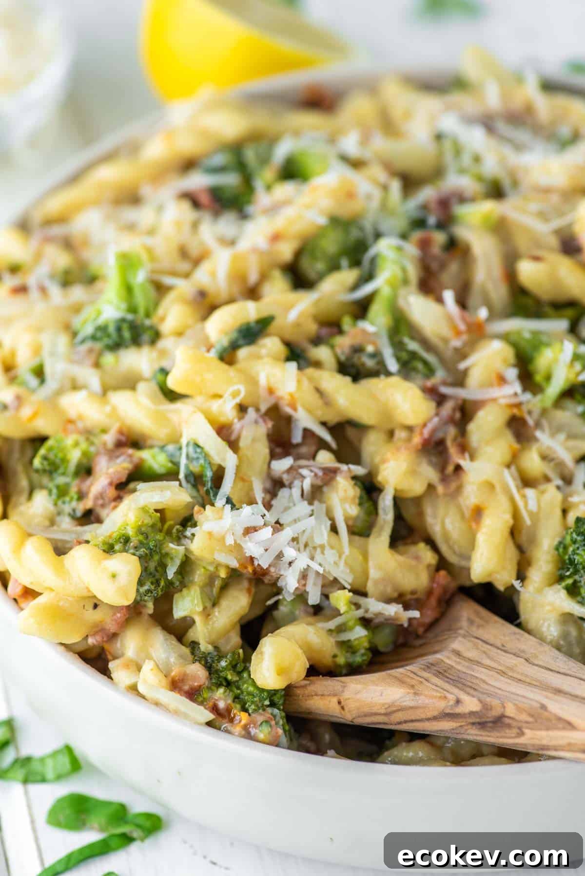 wooden spoon dipped in hummus pasta