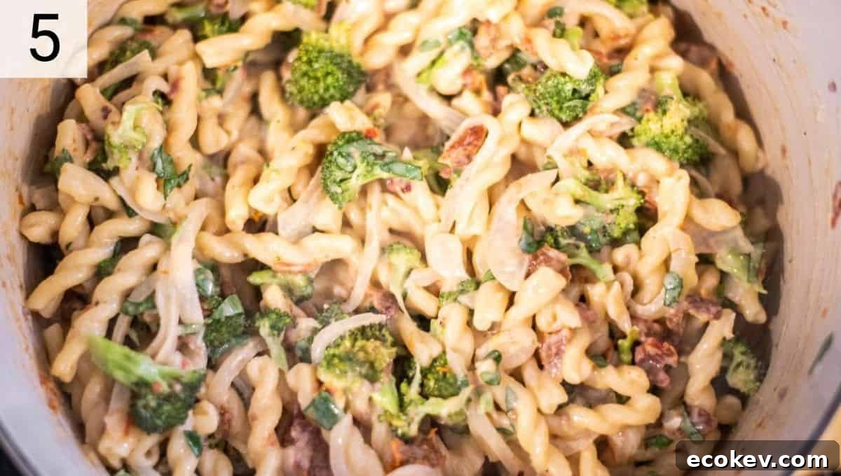 dutch oven filled with hummus pasta