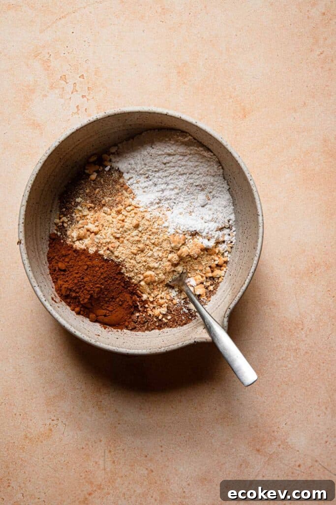 A bowl with ingredients to make unbaked chocolate cookies.