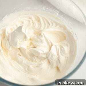 A glass bowl with vanilla bean whipped cream.