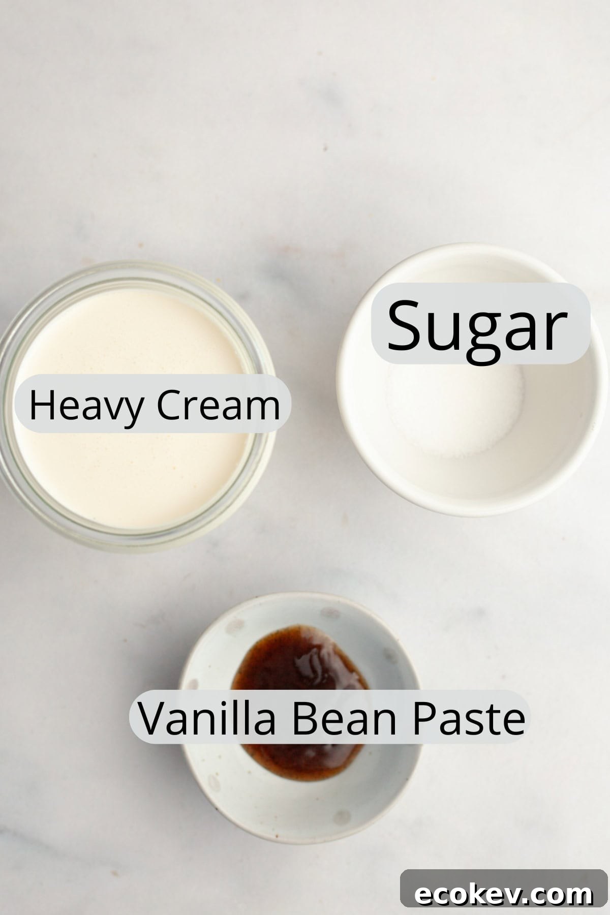 All the ingredients needed to make vanilla bean whipped cream, weighed out into small bowls.
