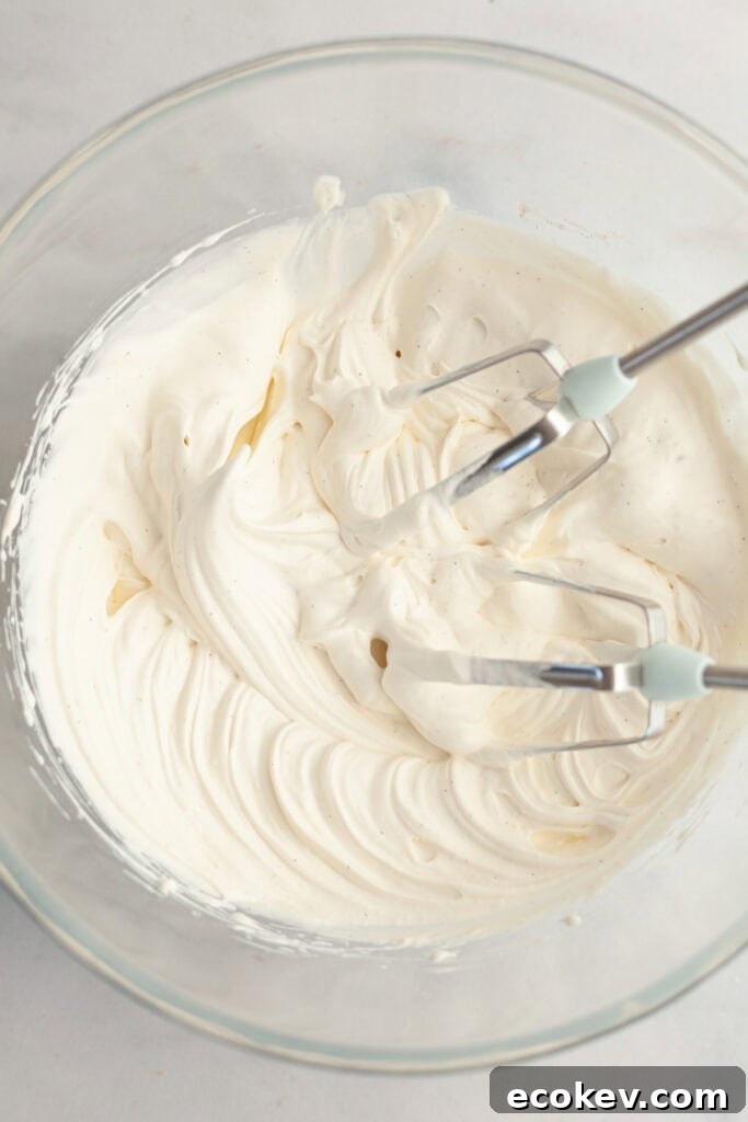 A glass bowl with vanilla bean whipped cream.