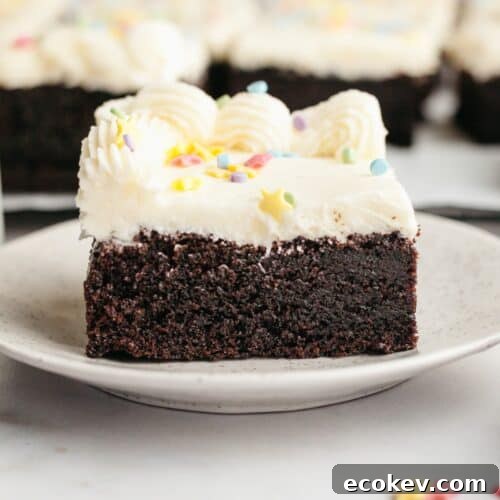 A slice of moist chocolate sheet cake with vanilla buttercream.