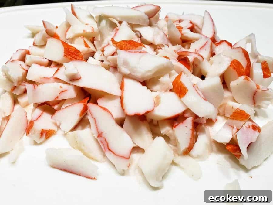 imitation crab meat chopped on a cutting board.