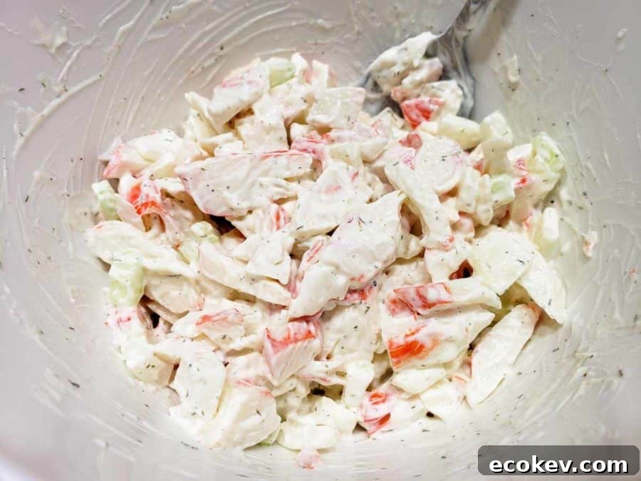 a bowl filled with imitation crab meat salad mixed together.