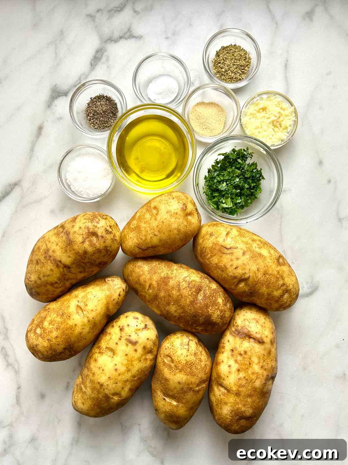 ingredients prepped in bowls; whole unpeeled potatoes.