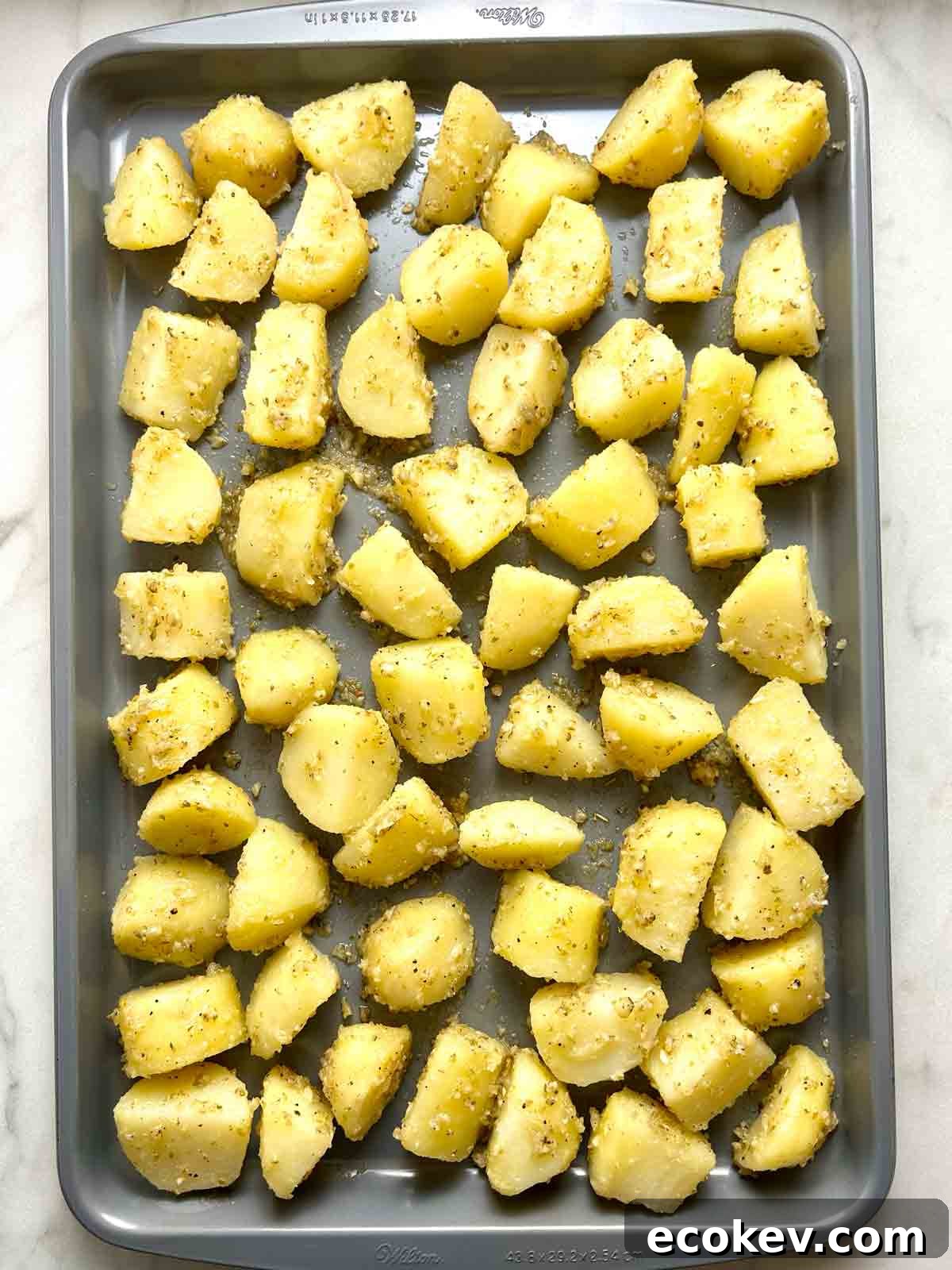 potatoes spread out on baking sheet.