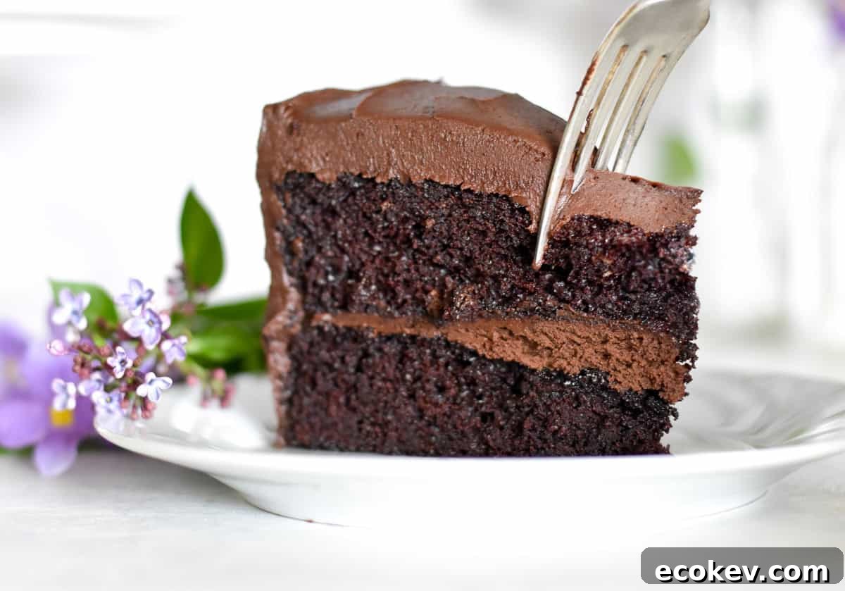 Slice of chocolate cake with fork digging in. 