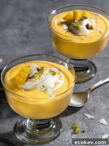 Two bowls of mango mousse in dessert cups