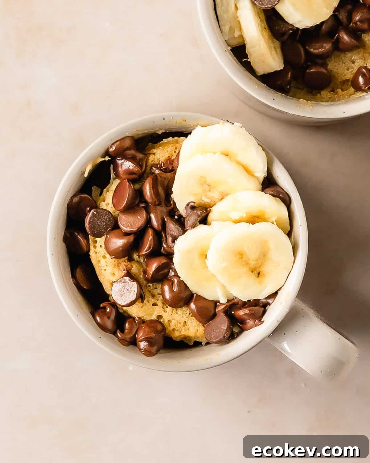 Banana mug cake is a moist, fluffy and super easy mug cake recipe that takes under 5 minutes to make. This banana cake in a mug is especially delicious when topped with lots of melty chocolate chips. Make this cozy banana bread in a mug cake for the perfect single serve breakfast, snack or dessert.
