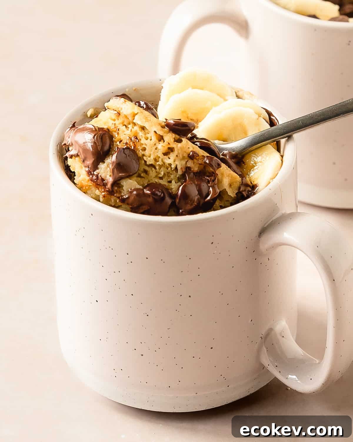 Banana mug cake is a moist, fluffy and super easy mug cake recipe that takes under 5 minutes to make. This banana cake in a mug is especially delicious when topped with lots of melty chocolate chips. Make this cozy banana bread in a mug cake for the perfect single serve breakfast, snack or dessert.