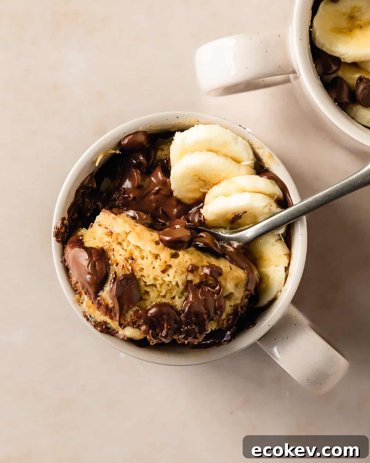 Banana mug cake is a moist, fluffy and super easy mug cake recipe that takes under 5 minutes to make. This banana cake in a mug is especially delicious when topped with lots of melty chocolate chips. Make this cozy banana bread in a mug cake for the perfect single serve breakfast, snack or dessert.