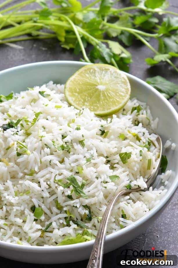instant pot cilantro lime rice chipotle copycat in a light blue bowl with spoon and lime
