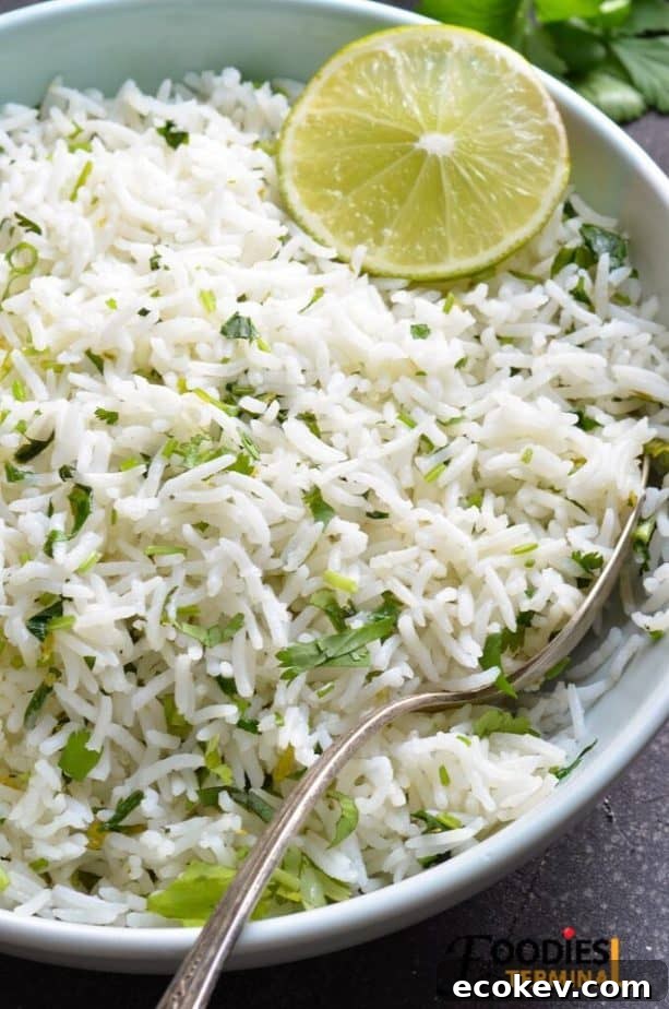best pressure cooker cilantro lime rice in a light blue plate with a silver spoon and lime