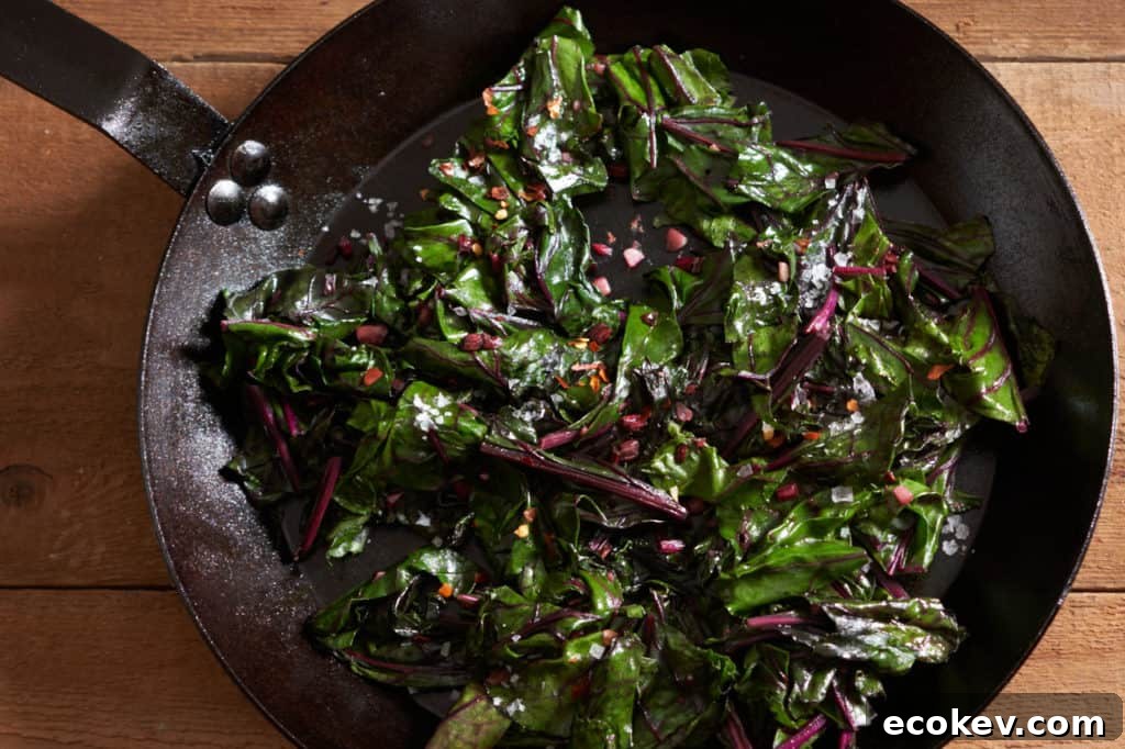 Sautéed beet greens in a cast iron skillet.