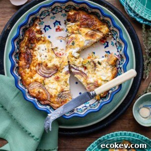 Crustless quiche sliced in a patterned ceramic pie dish