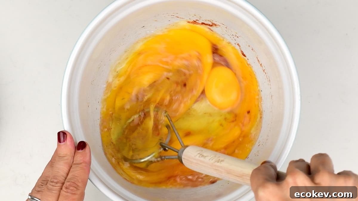 beating eggs and seasonings in a bowl