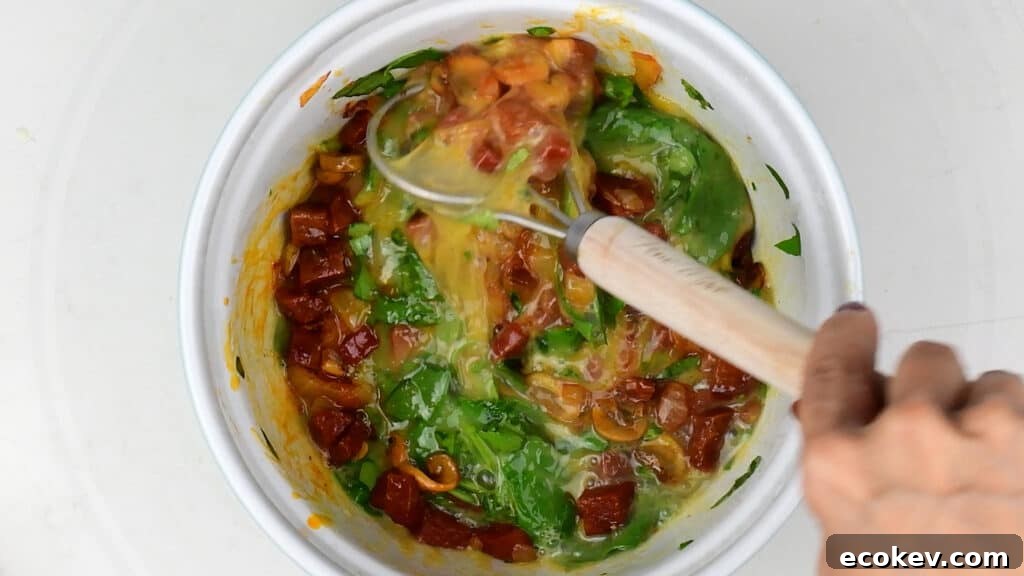 Mixing ingredients for keto frittata in bowl