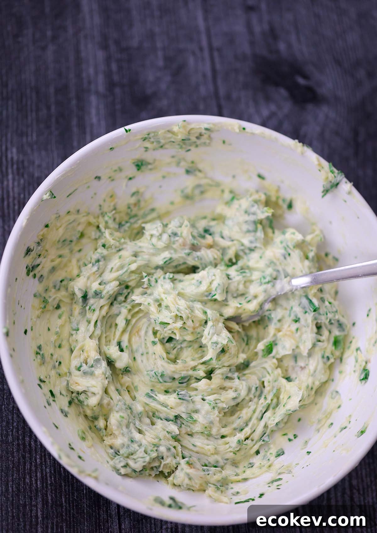 butter mixture in a white bowl with a fork.