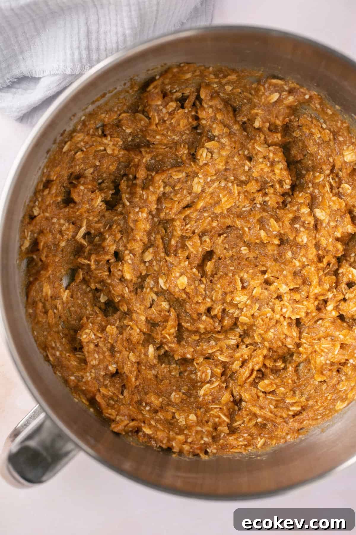 A bowl filled with a sticky dough that has oats in it.