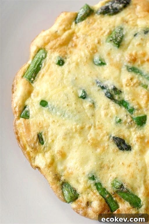 Asparagus Frittata sprinkled with Parmesan cheese.
