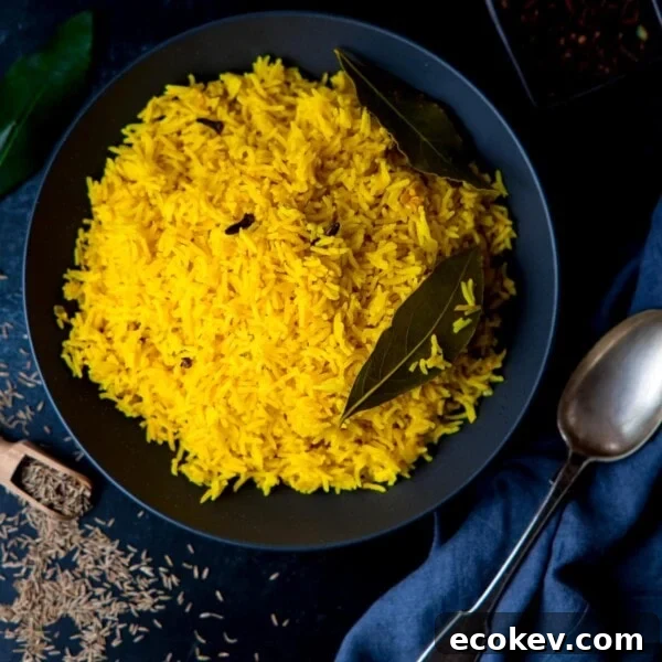 Square image of Pilau rice in a black bowl on a dark surface