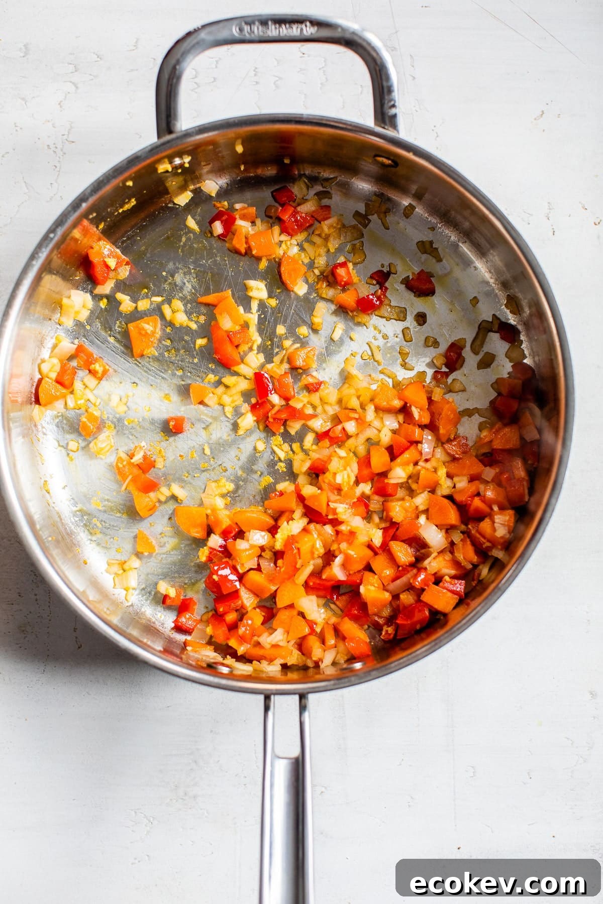 cooked carrots and diced bell pepper in a skillet