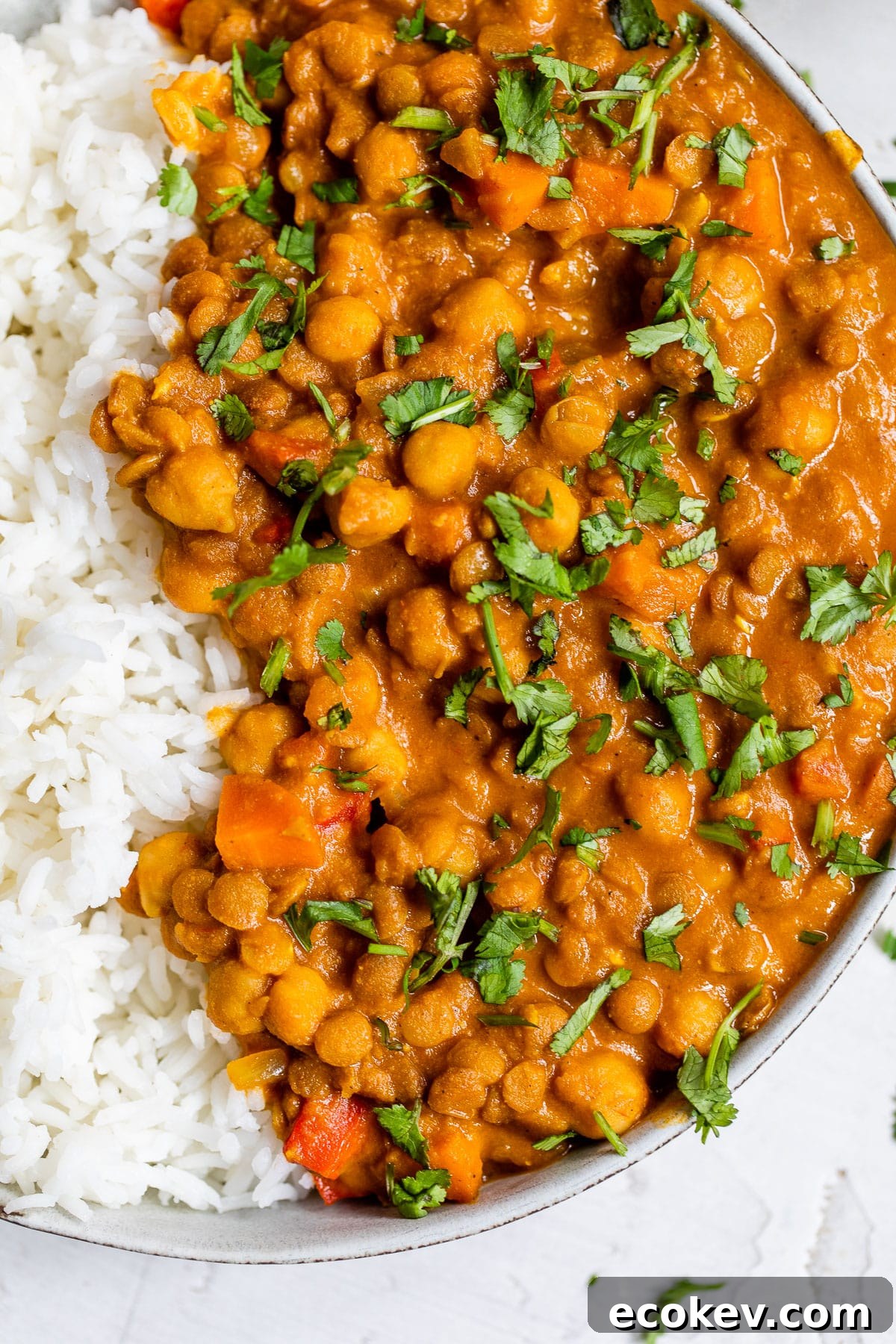 close up of cooked lentils and chickpeas in a curry sauce