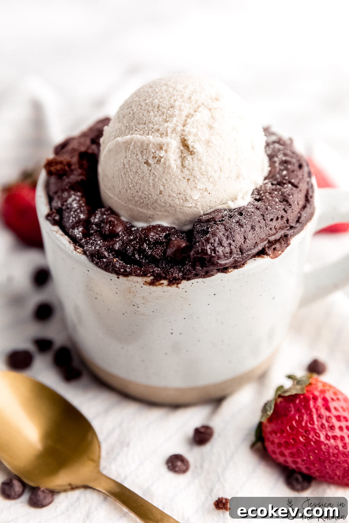 Close up photo of mug cake with a scoop of ice cream on top.