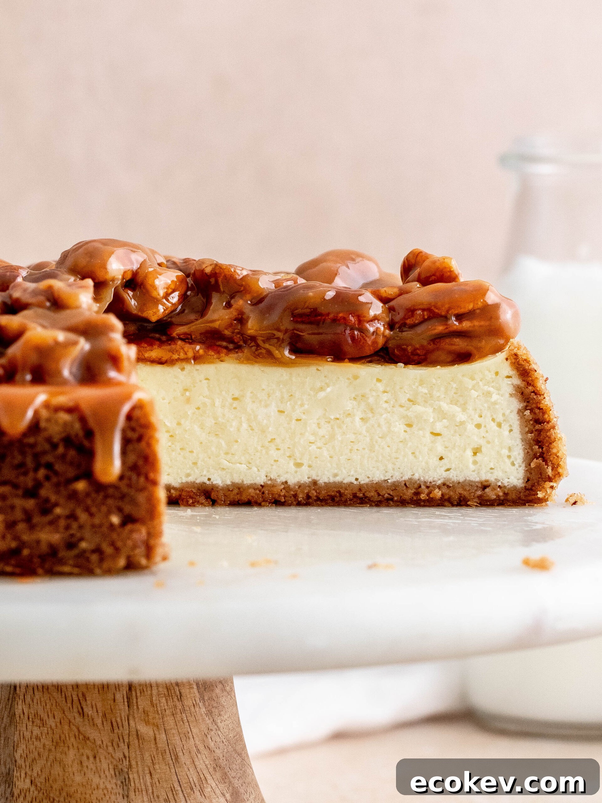 Caramel pecan cheesecake on a cake stand