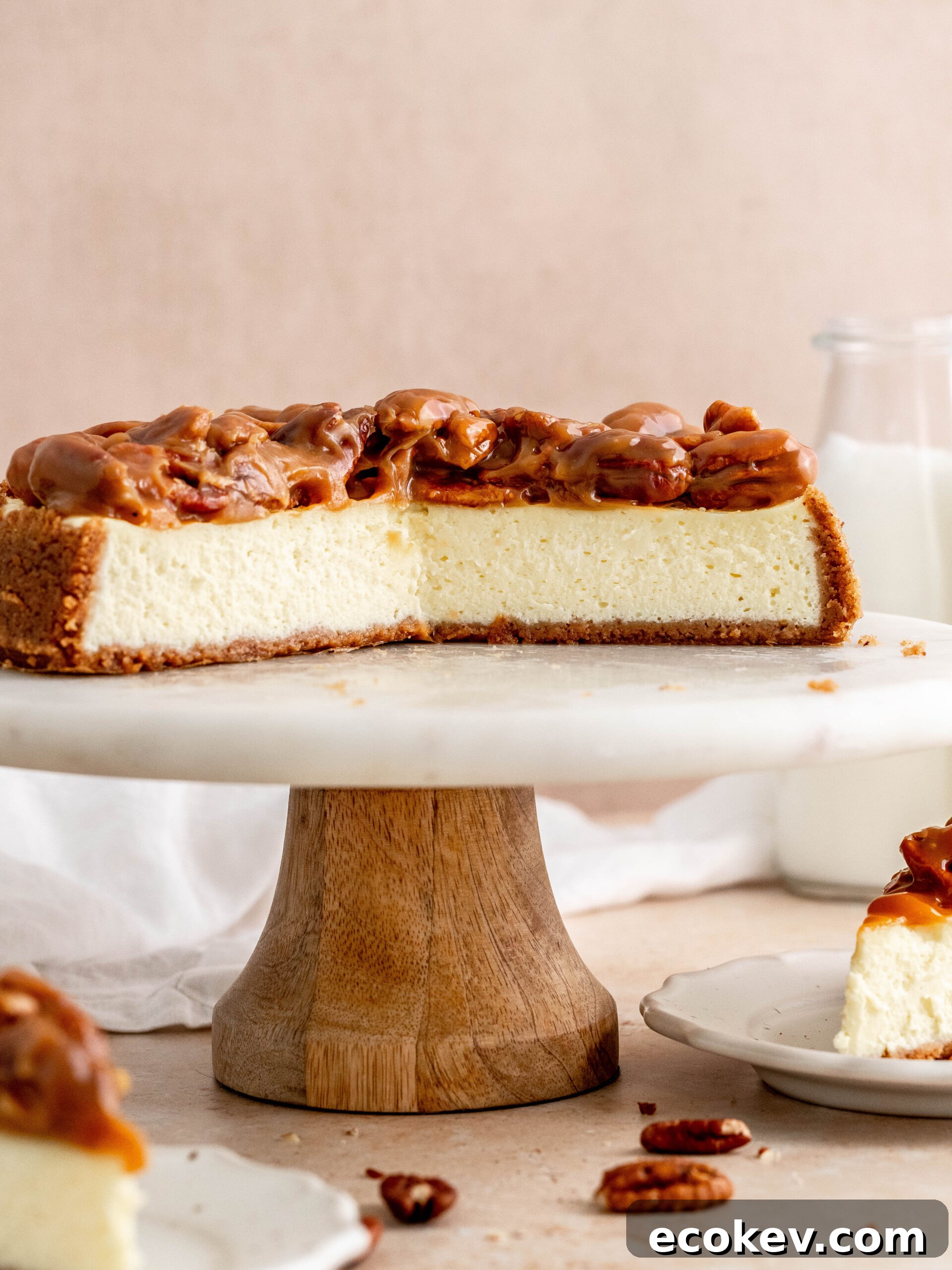 Caramel pecan cheesecake on a cake stand