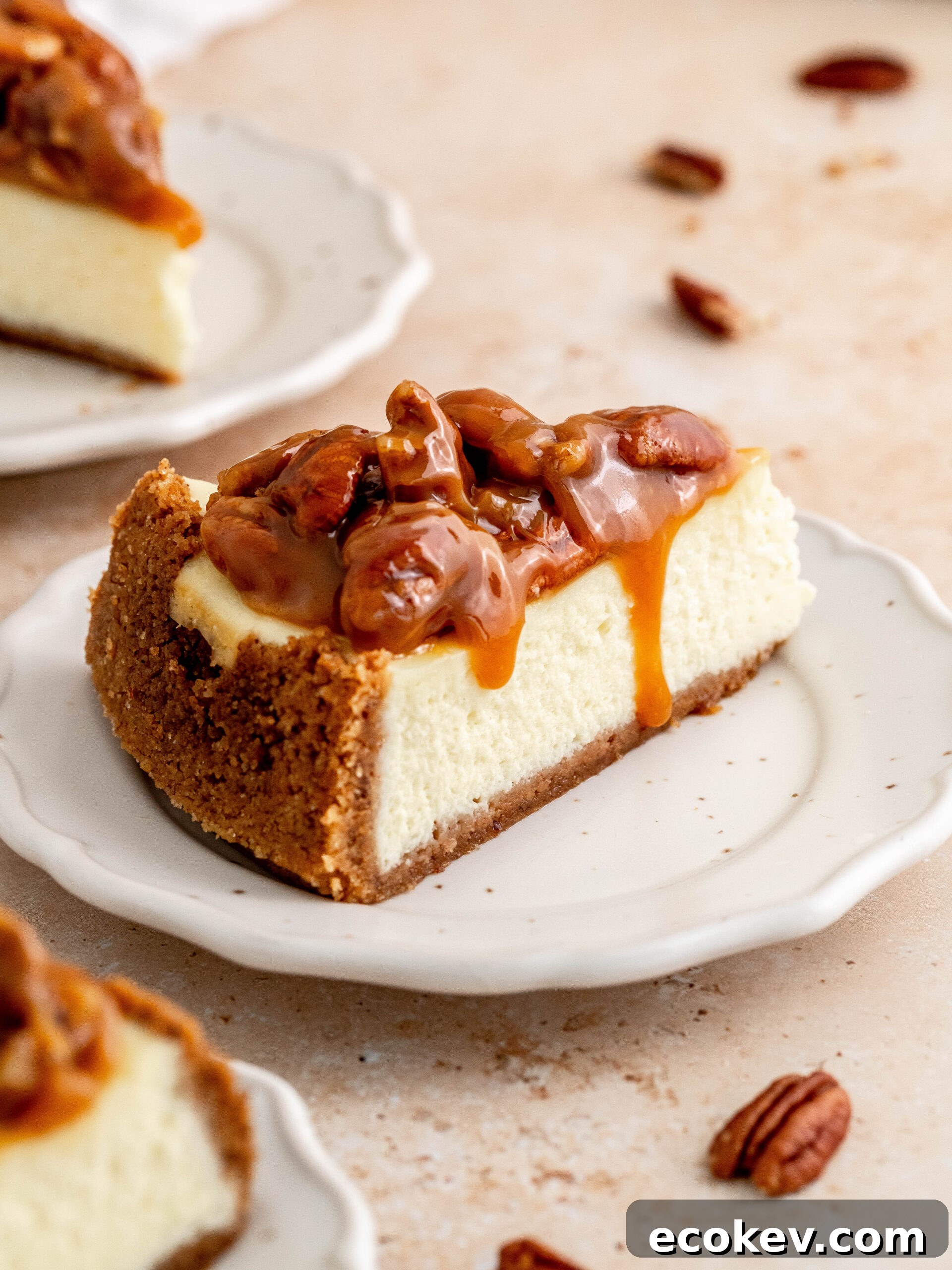 A slice of caramel pecan cheesecake on a plate.