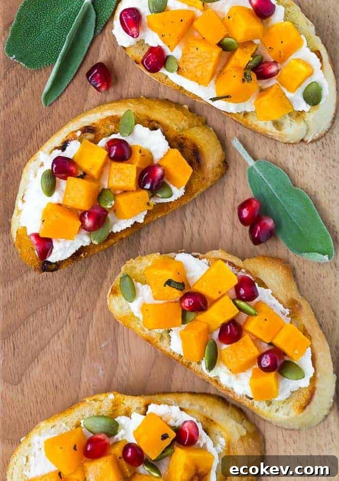 Image of butternut squash crostini topped with pomegranate and pepitas.