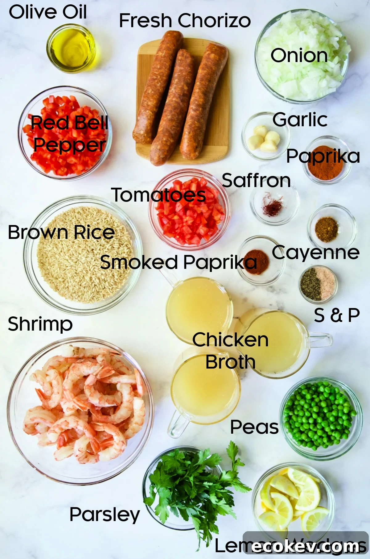 Ingredients for Brown Rice Paella with Shrimp and Chorizo in glass bowls.