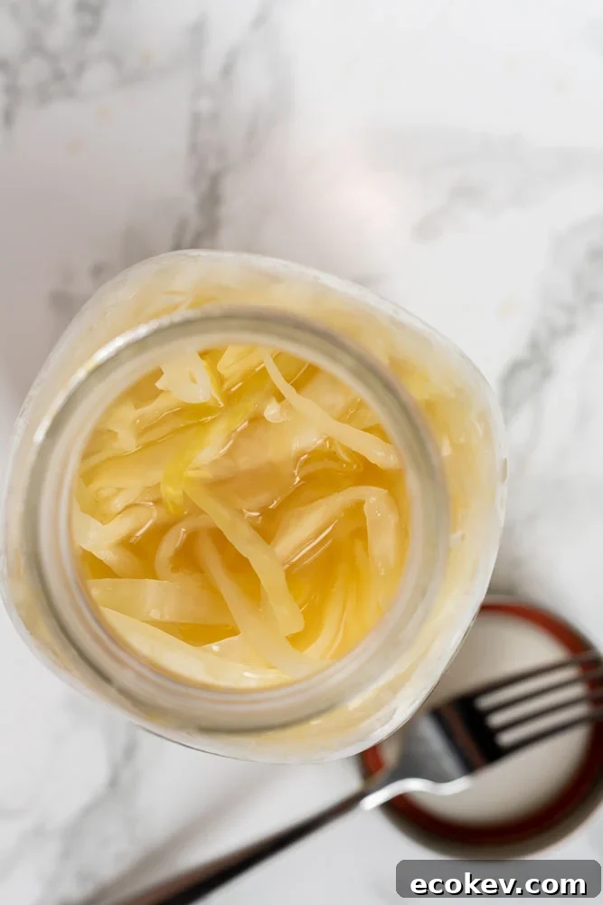 A top down view of sauerkraut in a mason jar.