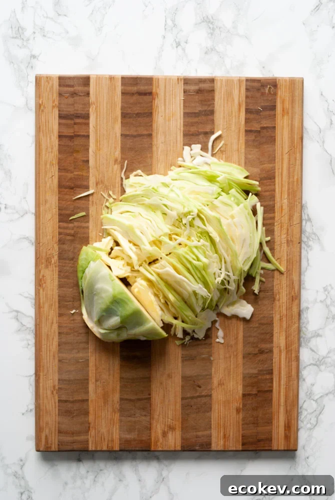 Sliced cabbage on a cutting board.