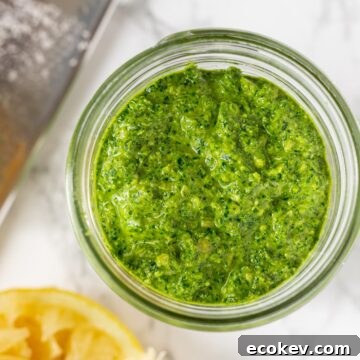 a close up view of kale pesto in a mason jar.